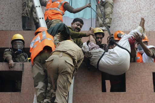 Rescue workers use ropes to evacuate people. AMRI/Kolkata Fire