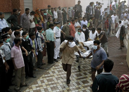 People help carry a patient out of the AMRI hospital. AMRI/Kolkata fire