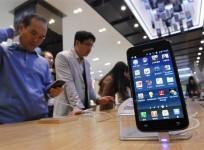 Customers look at Samsung Electronics' Galaxy series smartphones on display at a shop in Seoul