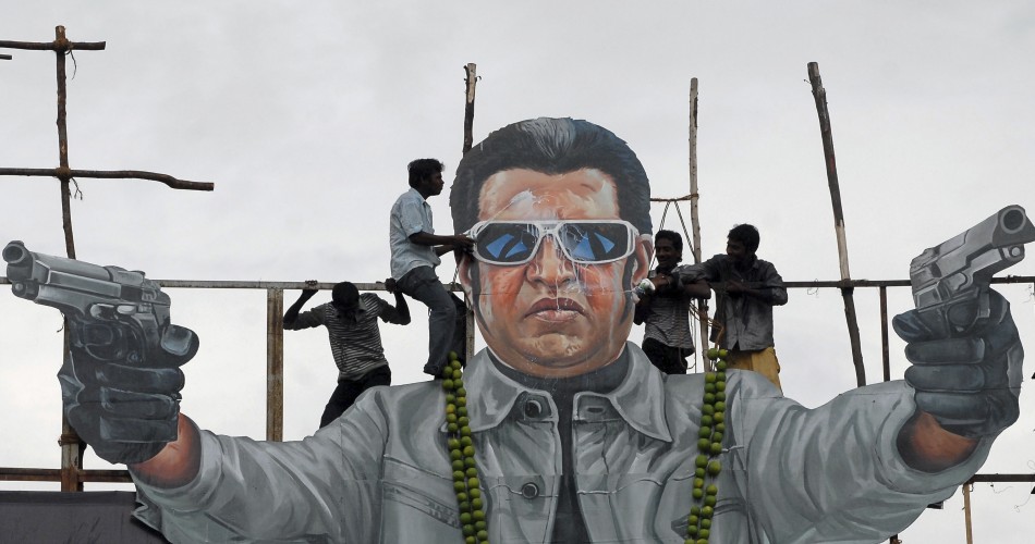 Fans of south Indian film star Rajinikanth pour milk as an offering over his cut-out on the release date of his new movie Rajinikanth