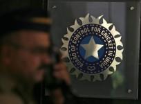 a-policeman-walks-past-a-logo-of-the-board-of-control-for-cricket-in-india-bcci-during-a-governing-council-meeting-of-the-indian-premier-league-ipl-at-bcci-headquarters-in-mumbai-april-26-2010