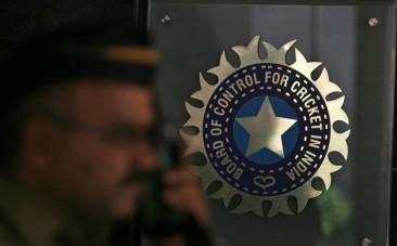 a-policeman-walks-past-a-logo-of-the-board-of-control-for-cricket-in-india-bcci-during-a-governing-council-meeting-of-the-indian-premier-league-ipl-at-bcci-headquarters-in-mumbai-april-26-2010