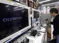 man-looks-at-olympus-corp-digital-cameras-at-an-electronics-store-in-tokyo