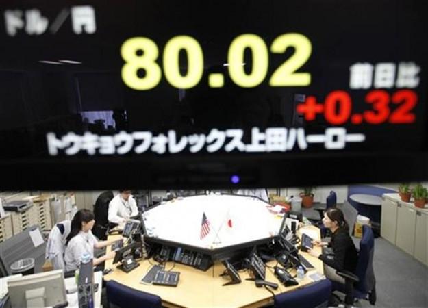 Foreign exchange dealers are seen beneath an electronic board displaying the Japanese Yen's exchange rate against the U.S. dollar, in Tokyo