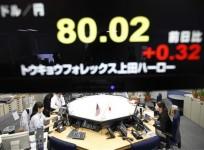 foreign-exchange-dealers-are-seen-beneath-an-electronic-board-displaying-the-japanese-yens-exchange-rate-against-the-u-s-dollar-in-tokyo