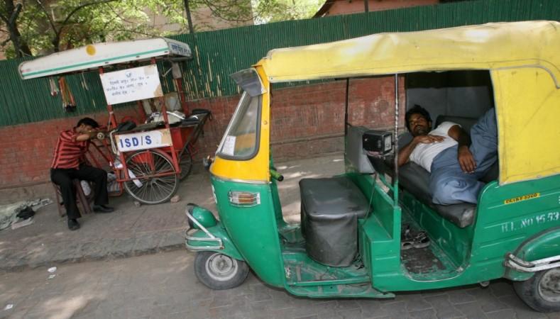 An auto-rickshaw driver taking a nap