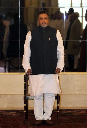 India's Railways Minister Mukul Roy stands to attention as the national anthem is played during the oath taking ceremony at the presidential place in New Delhi March 20, 2012. Mukul Roy