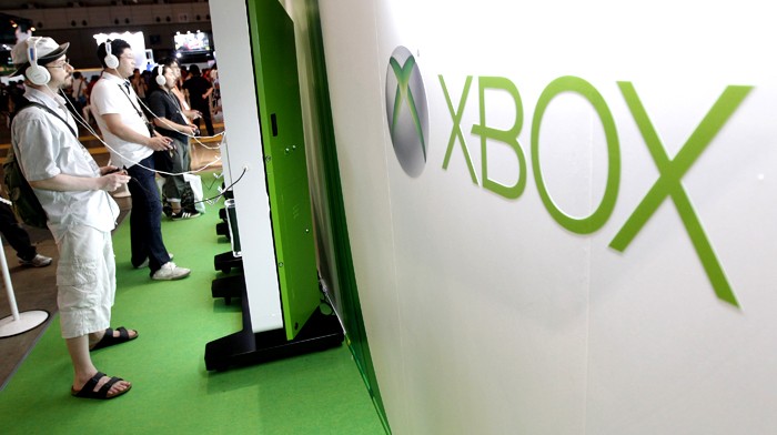 Visitors play with Microsoft's Xbox 360 consoles at the Tokyo Game Show in Chiba