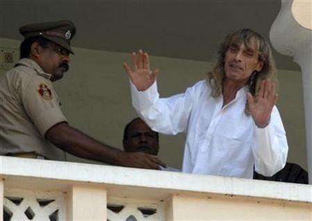 Freed Italian tour guide Paolo Bosusco, who was taken hostage by Maoist rebels, waves from a balcony of a guest house in Bhubaneswar April 12, 2012. Paolo Bosusco