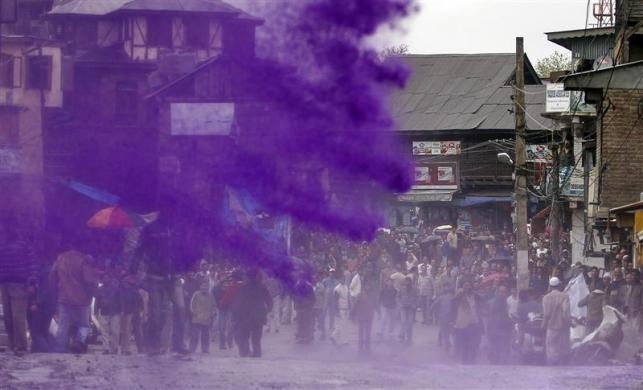 Protesting Kashmiri government employees are sprayed with dyed water by Indian police to disperse a demonstration in Srinagar April 10, 2012.