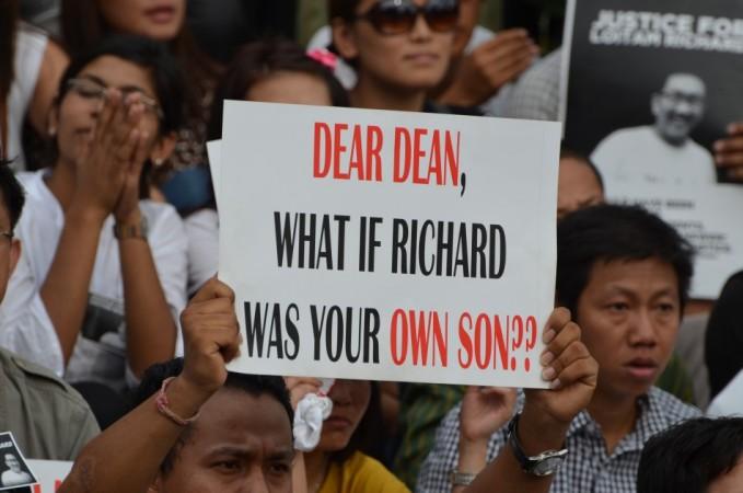 A protester holds a placard at a protest in Bangalore on April 29, 2012, demanding justice for Loitam Richard, who died after allegedly beaten up by his hostel mates. Justice for Loitam Richard