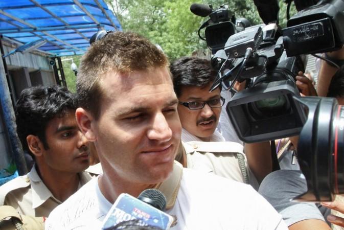 Australian cricketer Luke Pomersbach (C), surrounded by media, leaves the hospital on his way to a local court for a hearing in New Delhi May 18, 2012. Pomersbach has been arrested on molestation and assault charges, a senior Delhi Police official said on Friday. The 27-year-old was alleged to have molested a woman and physically attacked her male friend in a city hotel during a party after Pomersbach's Bangalore team had beaten Delhi in an Indian Premier League (IPL) match on Thursday.