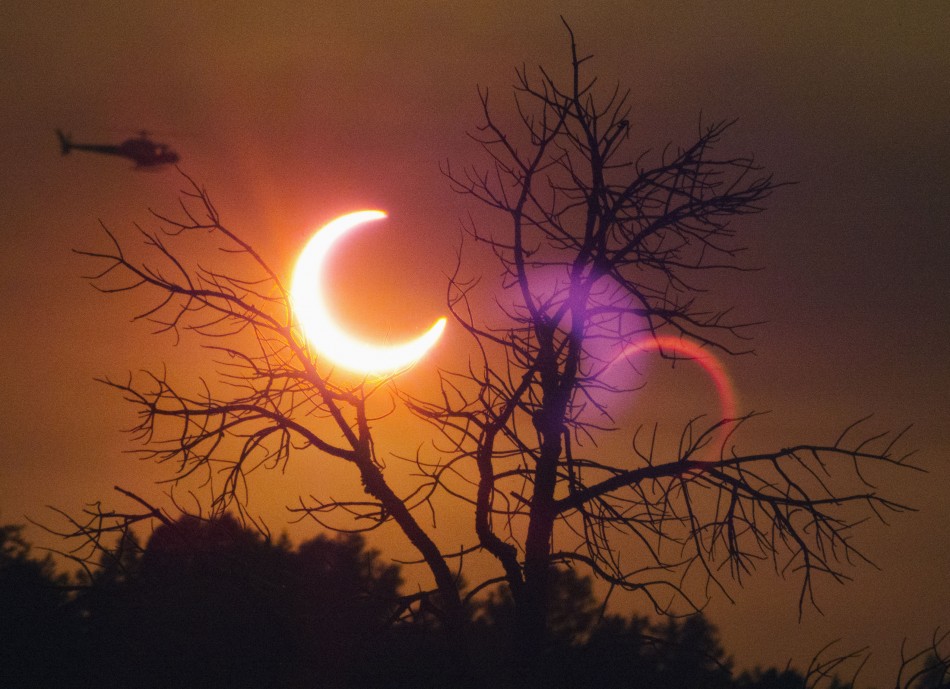 A helicopter flies past the solar eclipse near Payson Annual solar eclipse