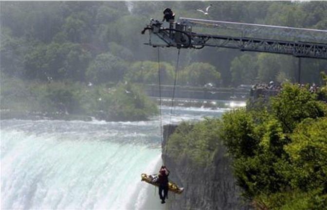 Niagara Falls firefighter Matt Rozon and an unidentified man are lifted from the Niagara gorge by an aerial fire truck in Niagara Falls May 21, 2012. Credit: Reuters Niagara Falls firefighter Matt Rozon and an unidentified man are lifted from the Niagara gorge by an aerial fire truck in Niagara Falls May 21, 2012.