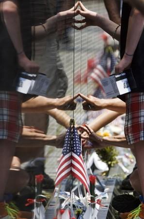 People touch the Vietnam Veterans Memorial wall