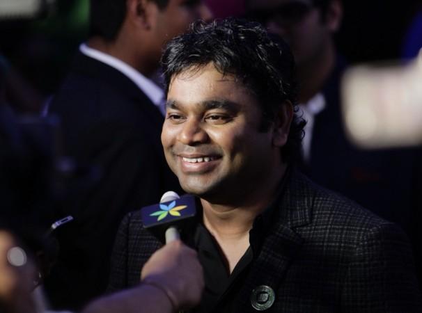 Music director A R Rahman smiles while speaking to a reporter upon his arrival on the green carpet for IIFA Awards 2012 in Singapore IIFA Awards 2012