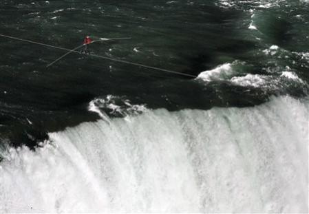 Nik Wallenda, has made a historic tightrope crossing over roaring Niagara Falls on Friday night (Reuters) Nik Wallenda