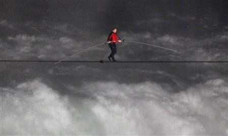 Nik Wallenda, has made a historic tightrope crossing over roaring Niagara Falls on Friday night (Reuters) Nik Wallenda