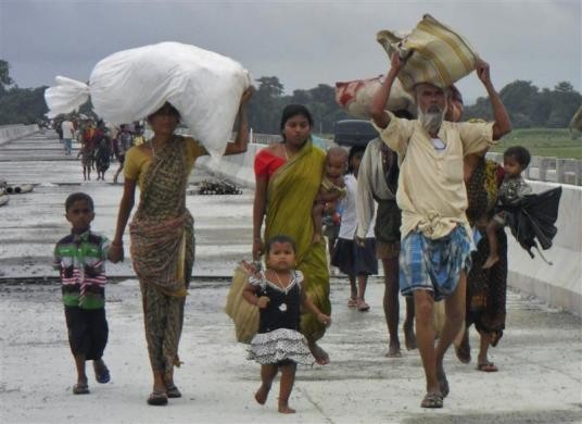 Villagers with their belongings move to relief camps as they leave their locality after violence at Chirang district in Assam Assam Violence