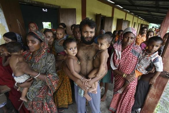 Villagers affected by ethnic riots, along with their children, are pictured at a relief camp near Kokrajhar town in Assam Assam Violence