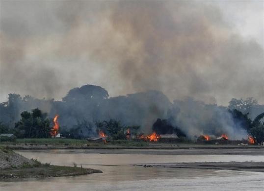 Flames erupt from huts built on the banks of river Gourang during violence near Kokrajhar town in Assam. Assam Violence
