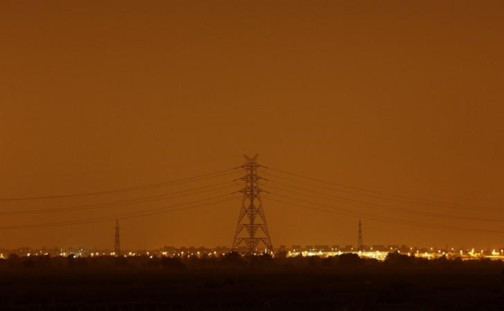 An electric pylon carrying high tension wires is pictured in front of a residential complex after electricity was restored in New Delhi (Reuters) Blackouts in India
