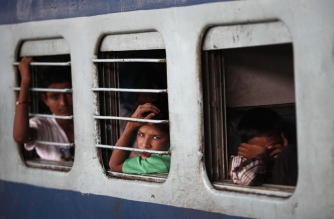 Passengers sit in a train as they wait for electricity to be restored at a railway station in New Delhi (Reuters) Blackouts in India