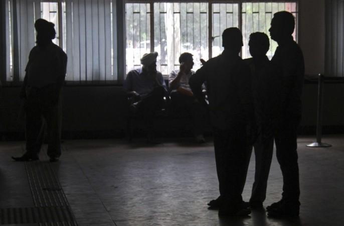 People stand inside the driving registration and license authority office during a power-cut in Chandigarh (Reuters) Blackouts in India
