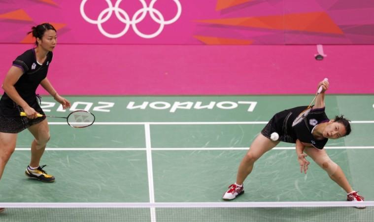Taiwan's Cheng Wen-Hsing (L) and Chien Yu-Chin plays against Japan's Mizuki Fujii and Reika Kakiiwa during their women's doubles group play stage group B badminton match at the London 2012 Olympic Games at the Wembley Arena Cheng Wen-Hsing, Chien Yu-Chin