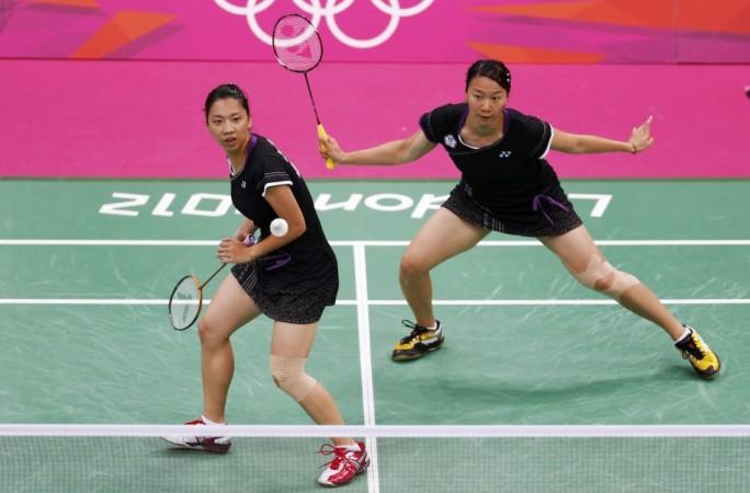Taiwan's Cheng Wen-Hsing (L) and Chien Yu-Chin plays against Japan's Mizuki Fujii and Reika Kakiiwa during their women's doubles group play stage group B badminton match at the London 2012 Olympic Games at the Wembley Arena Cheng Wen-Hsing, Chien Yu-Chin