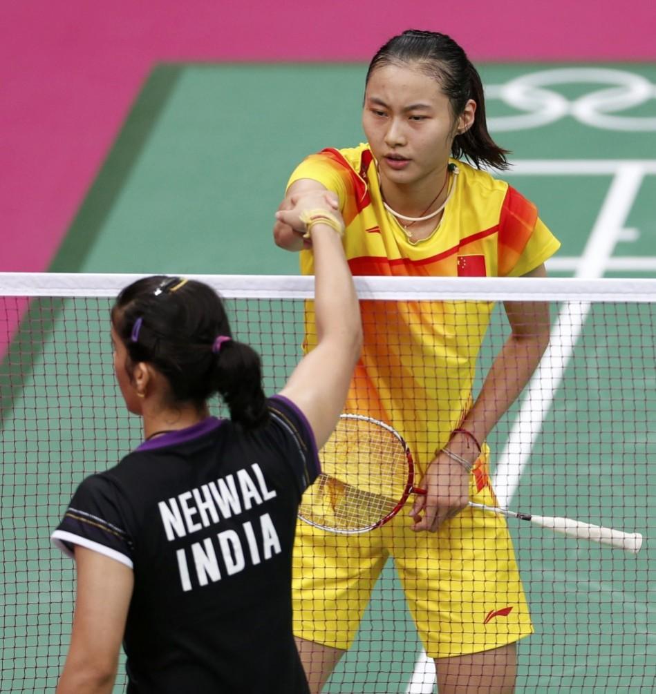 China's Yihan Wang shakes hands with India's Saina Nehwal after defeating her during their womens singles badminton semifinals match during London 2012 Olympic Games at Wembley Arena Wang Yihan, Saina Nehwal
