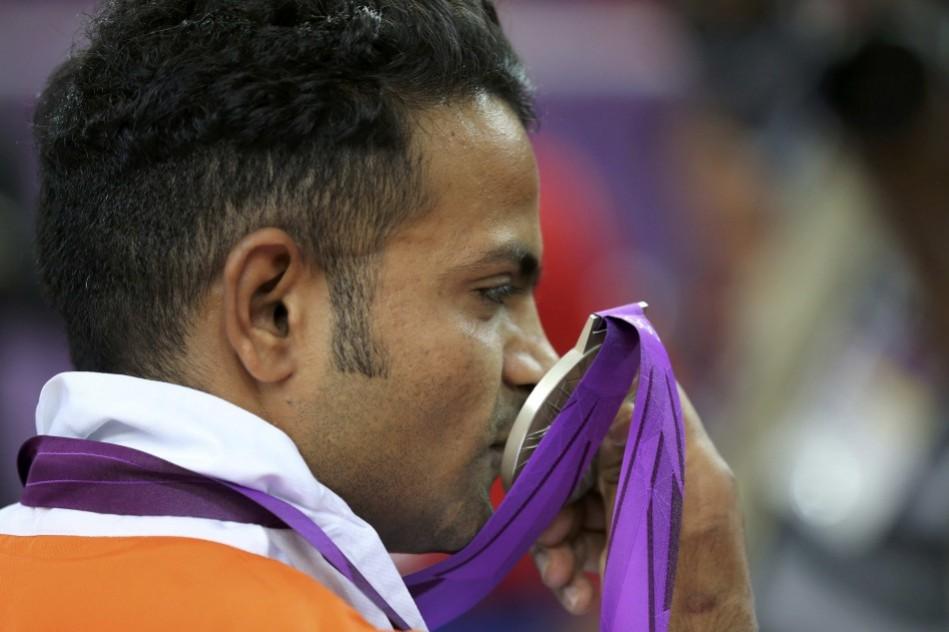 India's silver medal winner Vijay Kumar kisses his silver medal won in the men's 25m rapid fire pistol shooting event at the London 2012 Olympic Games Vijay Kumar