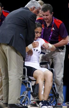Egypt's Khalil K Abir Abdelrahman is taken away on a wheel chair after injured on the women's 75Kg group A weightlifting competition at the ExCel venue at the London 2012 Olympic Games August 3, 2012.Reuters Egypt's Khalil K Abir Abdelrahman