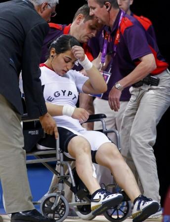 Egypt's Khalil K Abir Abdelrahman is taken away on a wheel chair after injured on the women's 75Kg group A weightlifting competition at the ExCel venue at the London 2012 Olympic Games August 3, 2012. Egypt's Khalil K Abir Abdelrahman