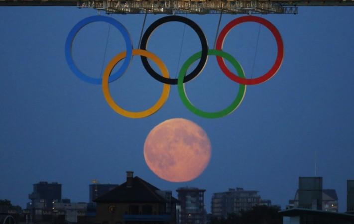 The full moon rises through the Olympic Rings hanging beneath Tower Bridge during the London 2012 Olympic Games August 3, 2012. REUTERS/Luke MacGregor Sixth Olympic ring