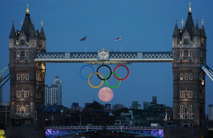 The full moon rises through the Olympic Rings hanging beneath Tower Bridge during the London 2012 Olympic Games August 3, 2012. REUTERS/Luke MacGregor Sixth Olympic ring