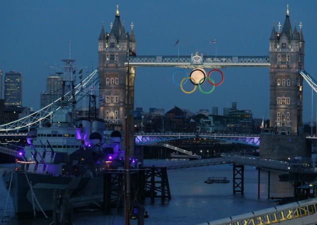 The full moon rises through the Olympic Rings hanging beneath Tower Bridge during the London 2012 Olympic Games August 3, 2012. REUTERS/Luke MacGregor Sixth Olympic ring