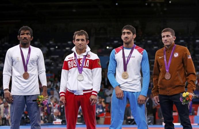 Azerbaijan's Toghrul Asgarov, Russia's Besik Kudukhov, India's Yogeshwar Dutt and Coleman Scott of U.S. pose at the podium of the Men's 60Kg Freestyle wrestling at the ExCel venue during the London 2012 Olympic Games Yogeshwar Dutt, Toghrul Asgarov, Besik Kudukhov, Coleman Scott