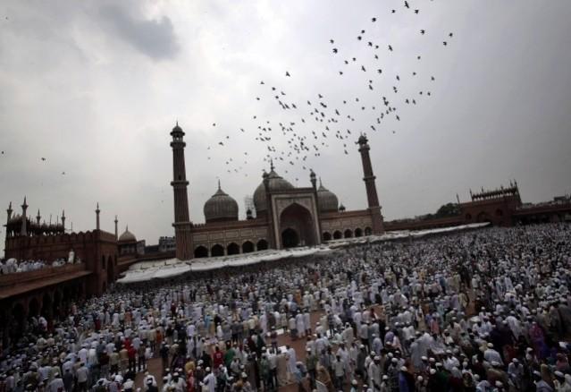 Muslims stand after offering last Friday prayers at the Jama Masjid (Grand Mosque) ahead of Eid-al-Fitr in the old quarters of Delhi, 17 August 2012. Eid-al-Fitr marks the end of Ramadan, the holiest month in the Islamic calendar, and is scheduled to be celebrated in India on 20 August. Eid al-Fitr 2012: The End of Ramadan Festivities Around the World