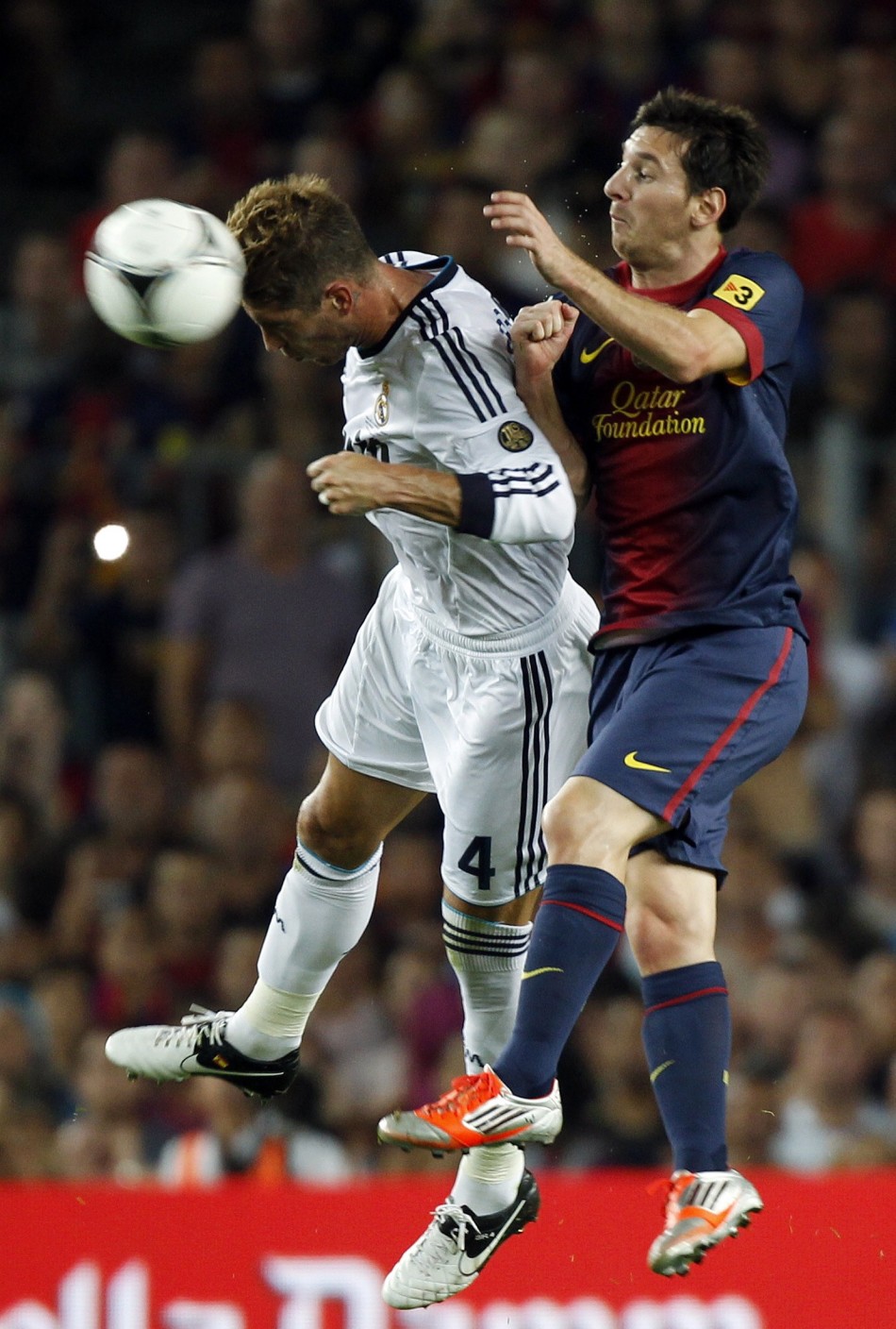 Barcelona's Messi and Real Madrid's Ramos challenge for the ball during their Spanish Super Cup first leg soccer match in Barcelona Messi, Ramos