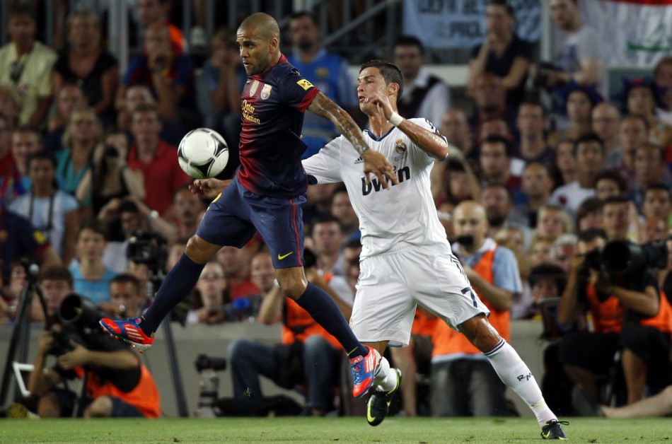 Barcelona's Alves and Real Madrid's Ronaldo challenge for the ball during their Spanish Super Cup first leg soccer match in Barcelona Barcelona, Real Madrid