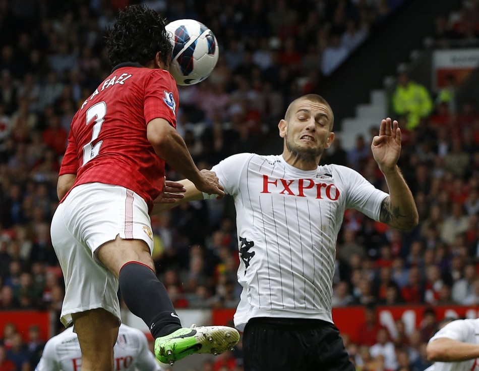 Manchester United's Rafael heads past Fulham's Petric to score during their English Premier League soccer match in Manchester Manchester United, Rafael