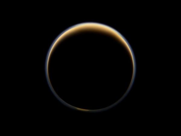 NASA's Cassini spacecraft looks toward the night side of Saturn's largest moon and sees sunlight scattering through the periphery of Titan's atmosphere and forming a ring of color. Source: NASA/JPL-Caltech/SSI Saturn and Titan