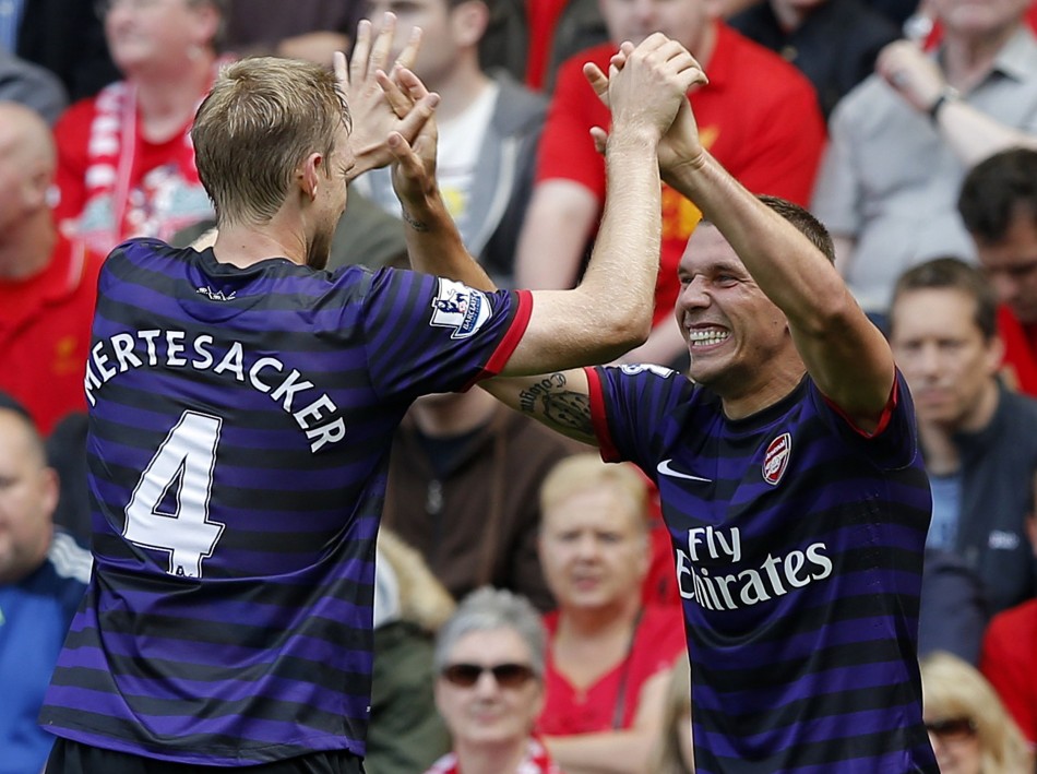 Arsenal's Podolski celebrates his goal against Liverpool with Mertesacker during their English Premier League soccer match at Anfield in Liverpool Arsenal