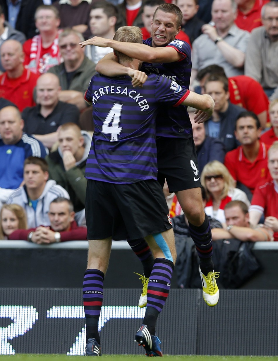 Arsenal's Podolski celebrates his goal against Liverpool with Mertesacker during their English Premier League soccer match in Liverpool Arsenal, Liverpool