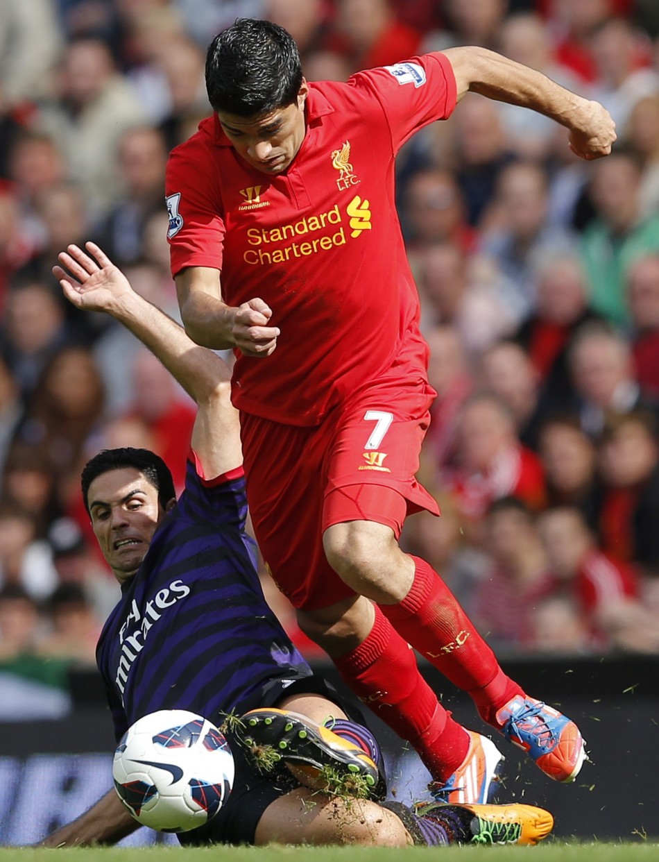 Arsenal's Arteta challenges Liverpool's Suarez during their English Premier League soccer match in Liverpool Arsenal, Liverpool