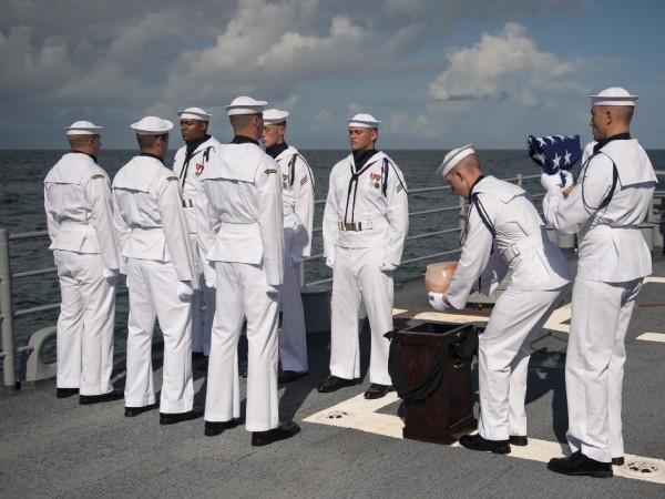 U.S. Navy personnel carry the cremated remains of Apollo 11 Commander Neil Armstrong during a burial at sea service aboard the USS Philippine Sea on Friday, Sept. 14. Credit: NASA/Bill Ingalls Neil Armstrong Laid to Rest in Atlantic