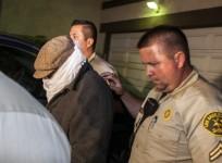 Nakoula Basseley Nakoula is escorted out of his home by Los Angeles County Sheriff's officers in Cerritos, California