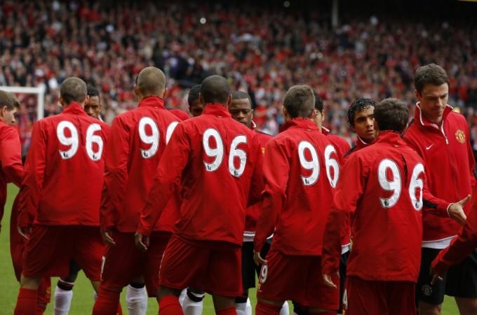 Liverpool and Manchester United players shake hands before their English Premier League soccer match in Liverpool Liverpool, Manchester United