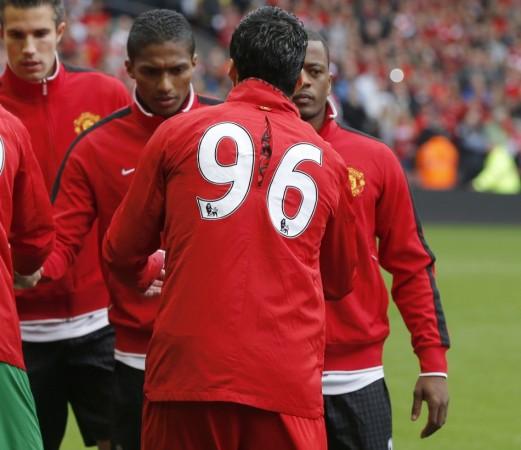 Liverpool's Luis Suarez and Manchester United's Patrice Evra shake hands before their English Premier League soccer match in Liverpool Luis Suarez, Patrice Evra